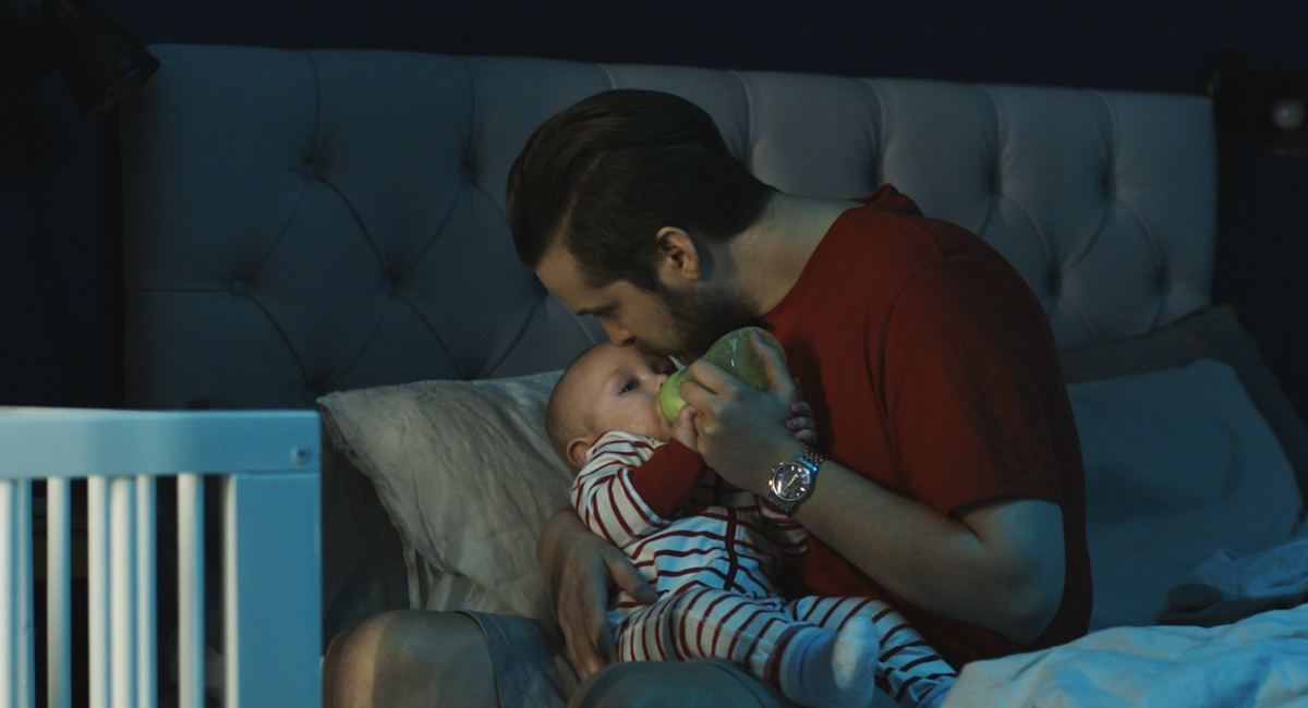 Father feeding baby with bottle