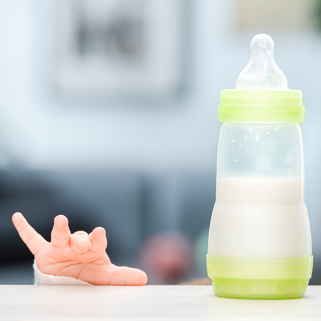 Baby's hand with a bottle