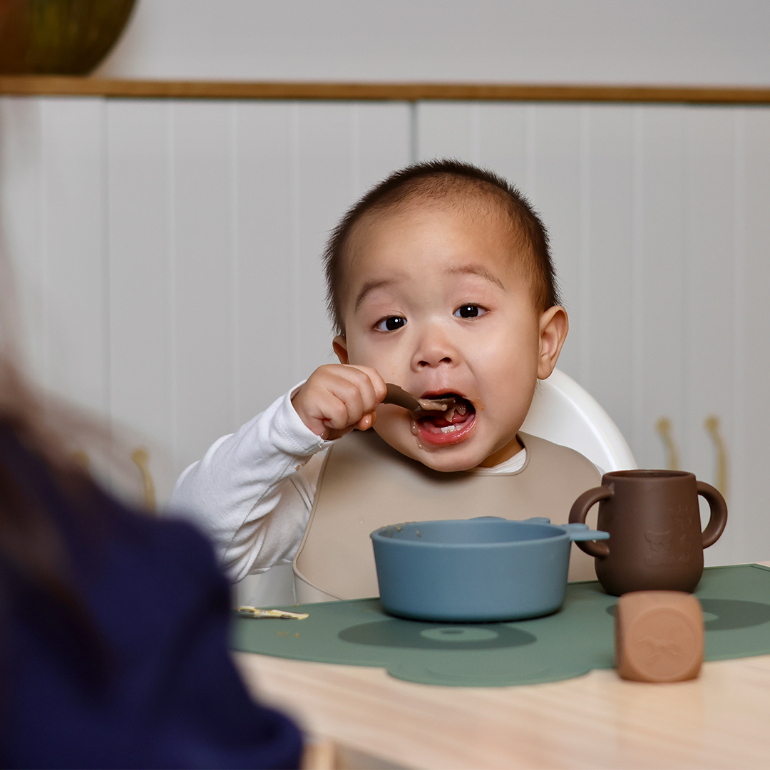 Baby eating with a spoon